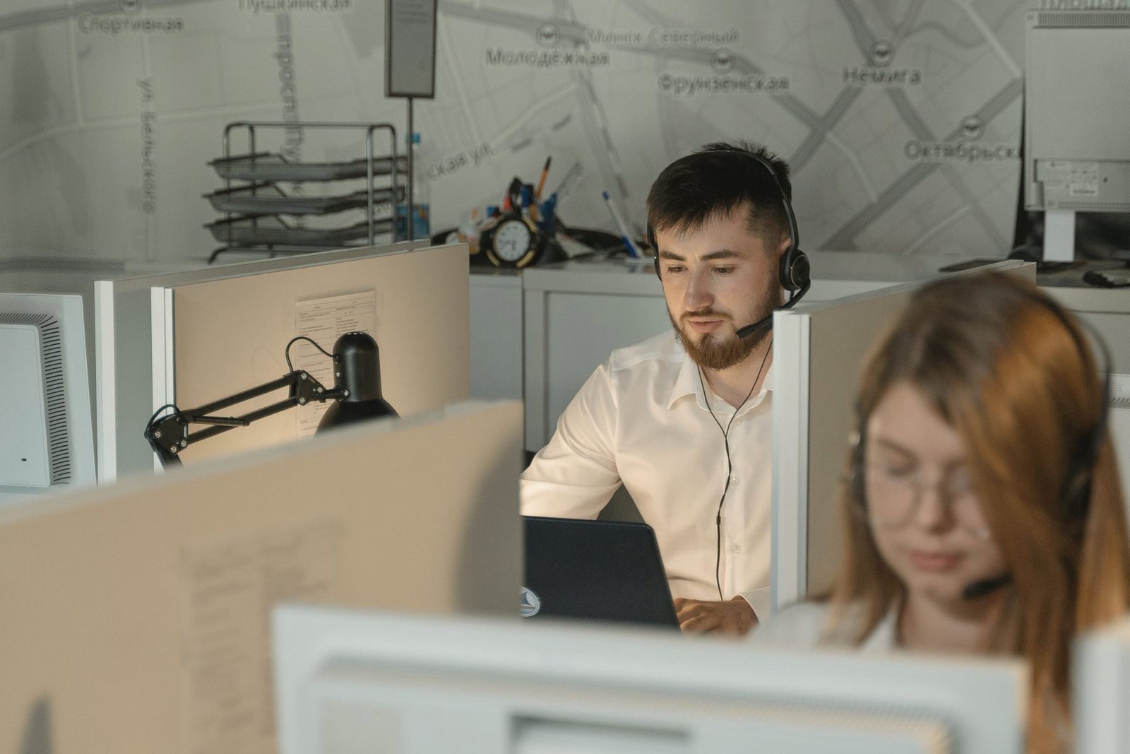 Operators seated along a row of desks.